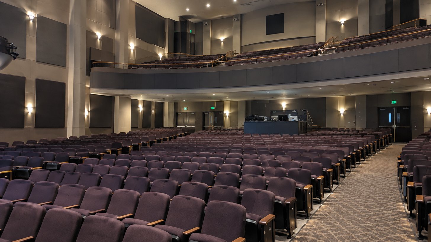 Performance venue auditorium with tiered seating, balcony and a rear production booth